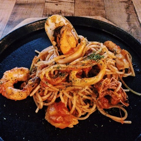 Spaghetti in delicious and rich marinara sauce with shrimps, mussels and calamari