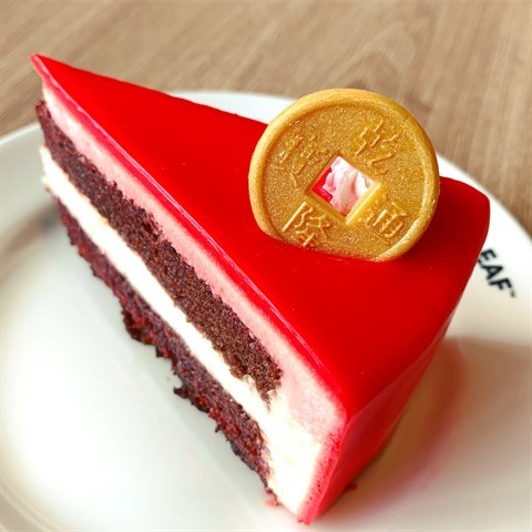 Moist cocoa-flavoured red velvet cake layered with luxurious white chocolate cream cheese frosting beautifully decorated for Chinese New Year.