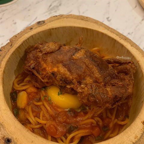 Spaghetti  pasta  cooked  with  chili  crab  sauce,  topped  with  a  soft  shell  crab  and  an  egg  yolk.  #timeline  #softshellcrab  #pasta